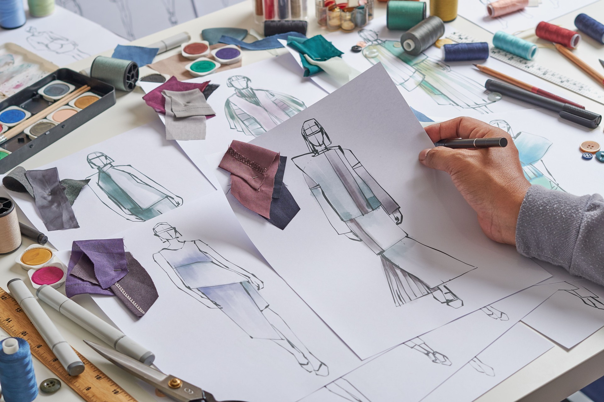 Fashion designer stylish drawings sketches textile fabric material Costume. Designer creative workshop studio.