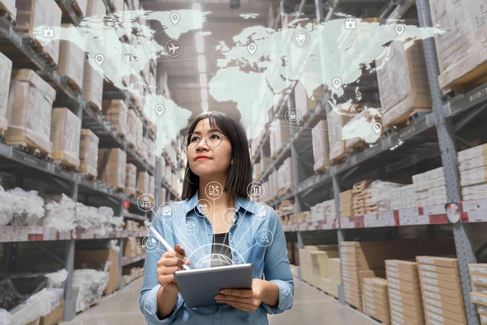 Portrait of happy young attractive asian entrepreneur woman looking at inventory in warehouse using smart tablet in management technology,  interconnected industry, asian small business sme concept.